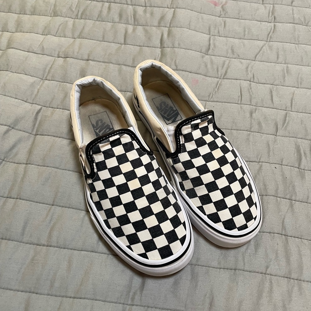 Vans black and white checkerboard slip ons.